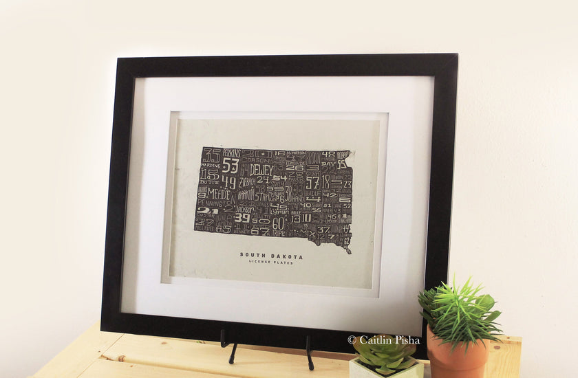 South Dakota License Plate Poster – Warm Black on Cream Background